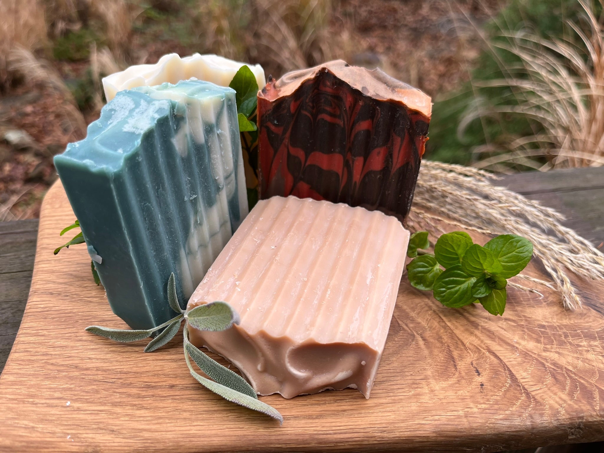 A group of handmade soaps on a wooden surface