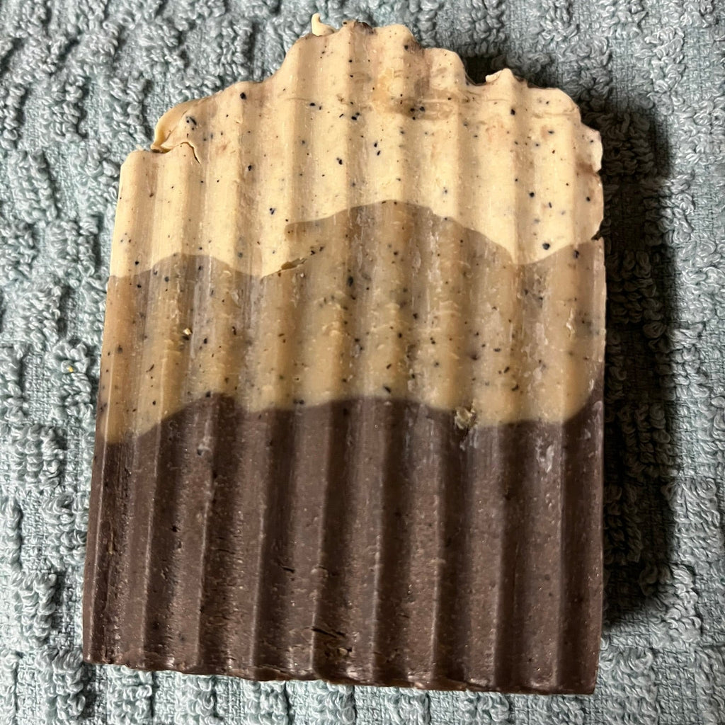 Two layered soap bar on a textured gray surface