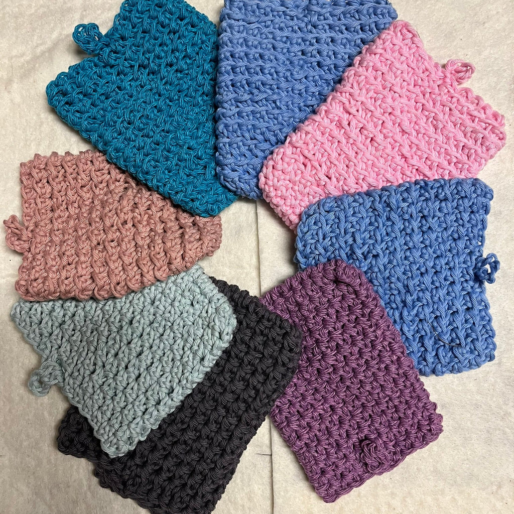 Set of crochet soap pouches in various colors.
