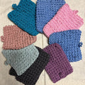 Set of crochet soap pouches in various colors.