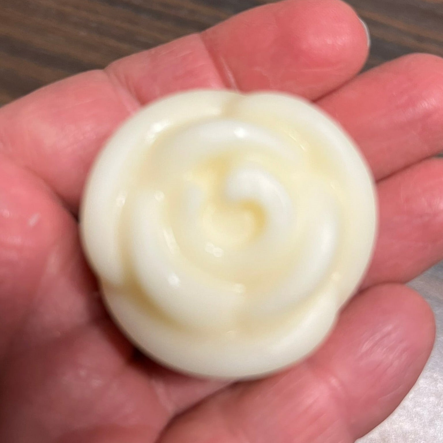 Solid lotion bar in hand