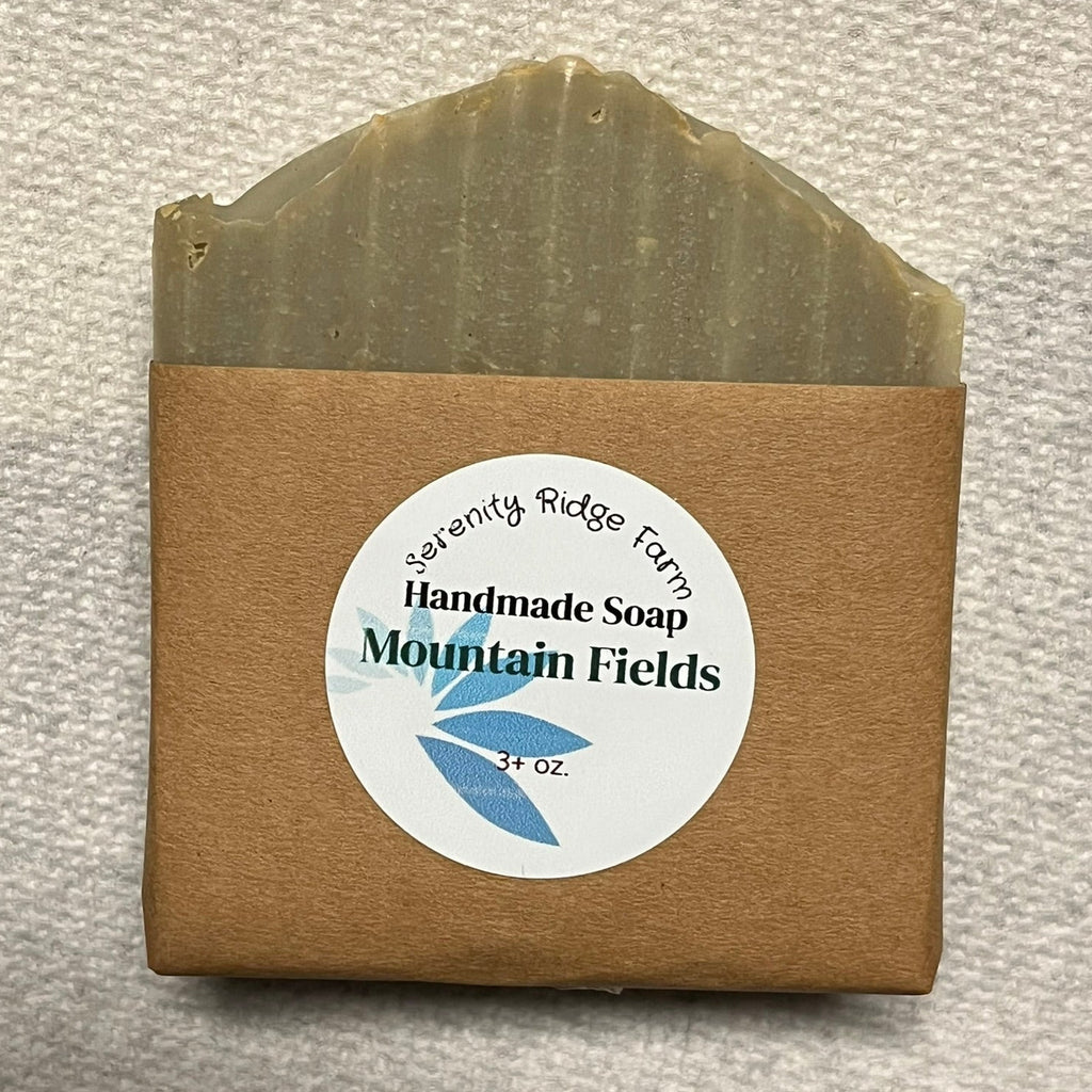 Handmade soap bar with a brown packaging label on a textured gray background