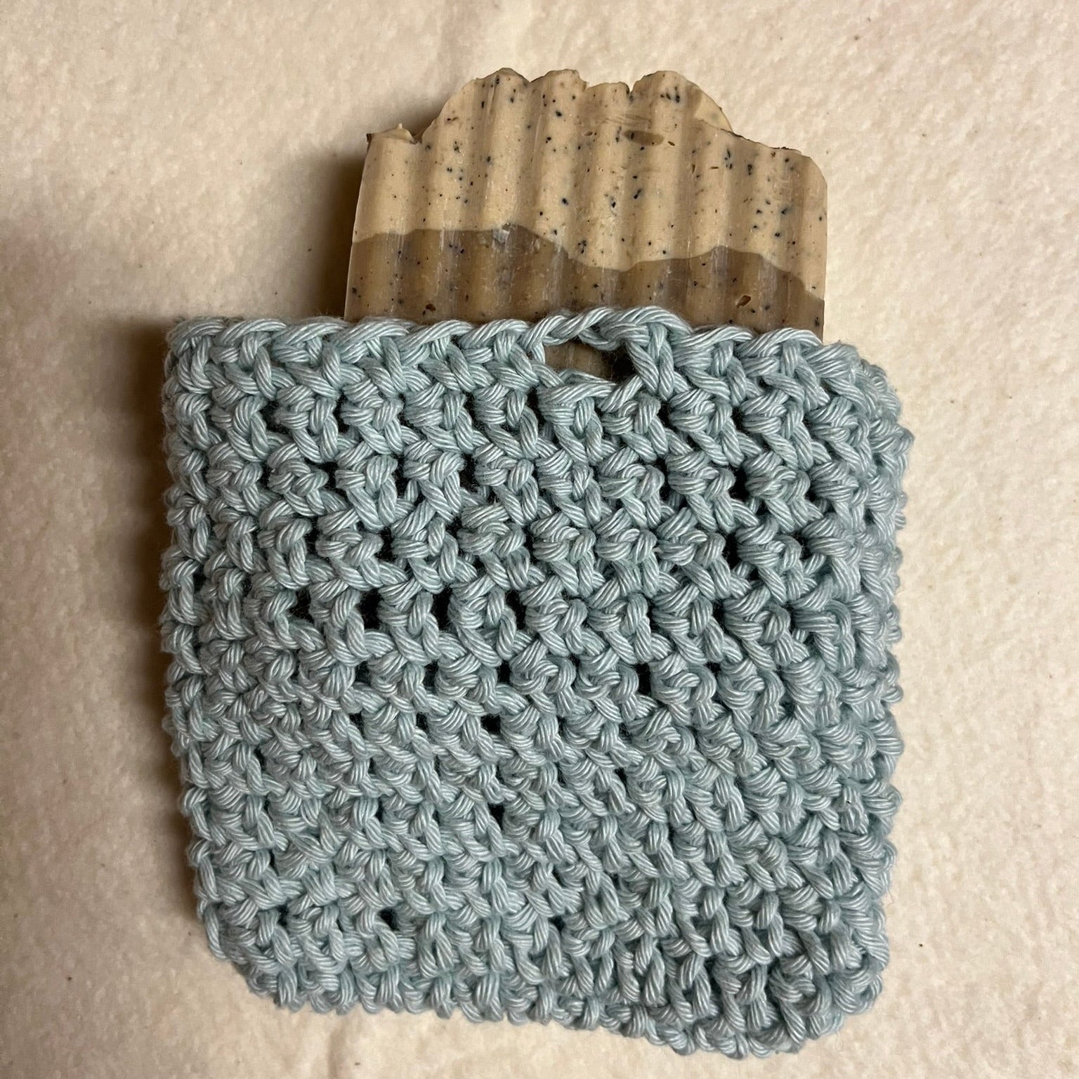 Seafoam colored crochet soap bag with bar of soap