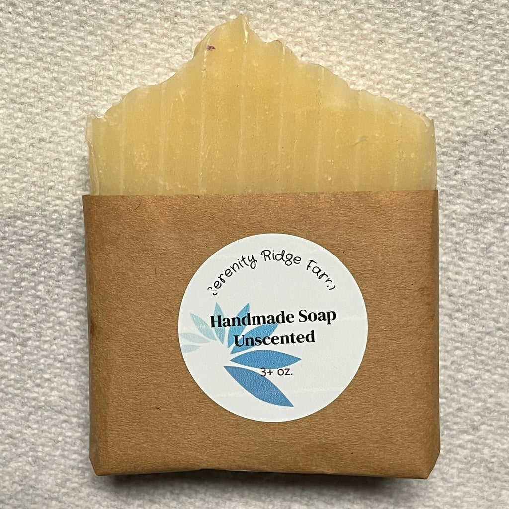 Handmade soap bar with a 'Serenity Ridge Farm' label on a textured surface