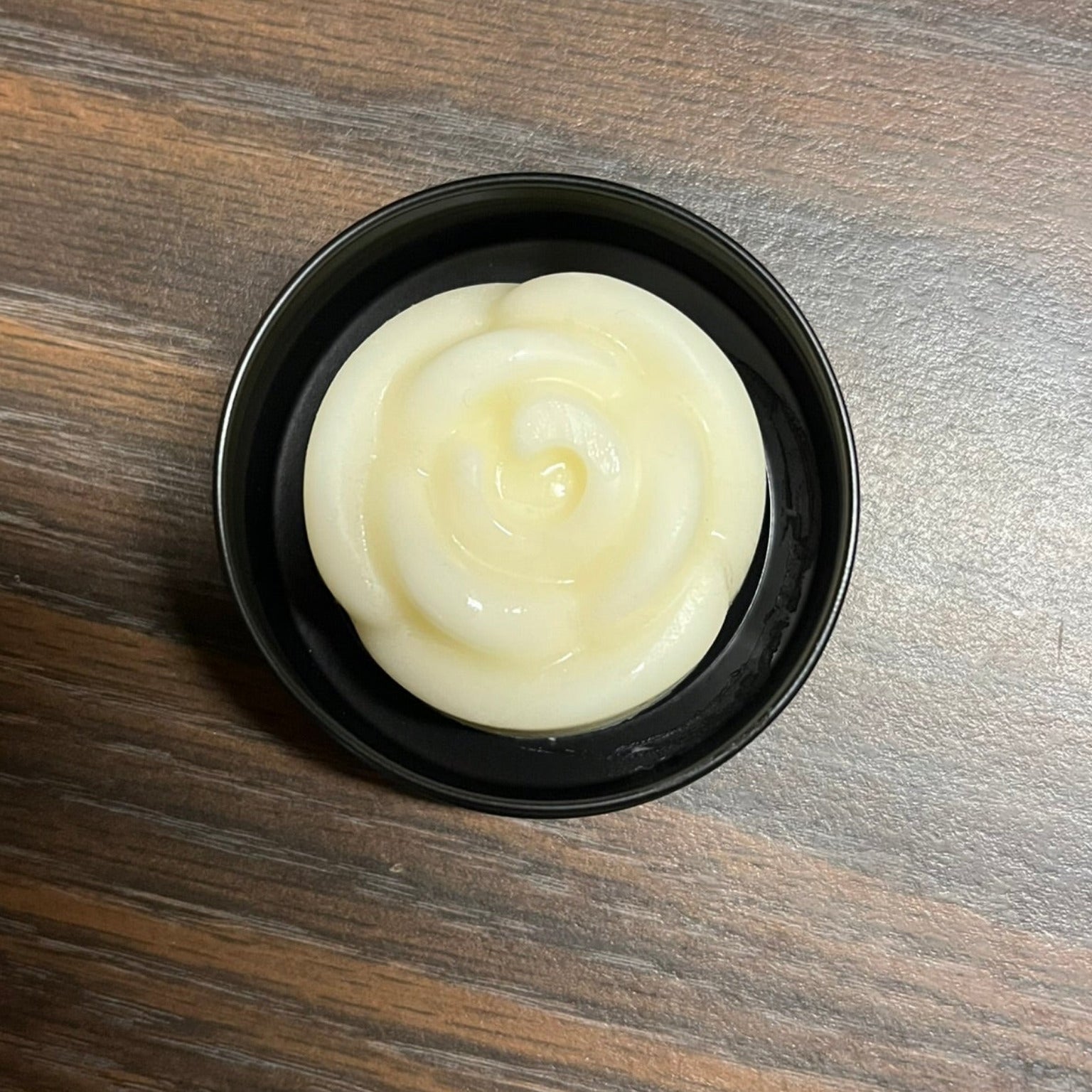 Solid lotion bar in black tin 